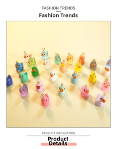 Close-up of colorful resin duck pendants in various hues with golden eye pins for DIY crafts