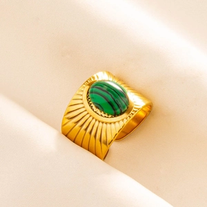 Detail of vintage gold-plated wide ring with malachite stone and sunburst engraving