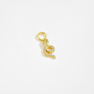 Macro shot of gold snake pendant with inlaid clear zircon stones on white background