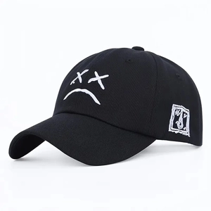 Black cotton baseball cap with white embroidered sad face and side graphic detail