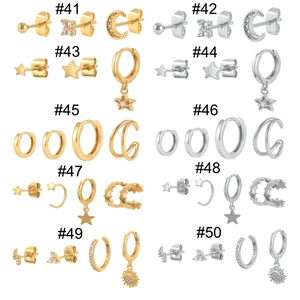 Detailed view of silver and gold earring sets with S925 hallmarks and cubic zirconia