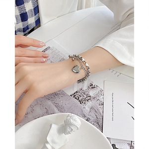 Layered stainless steel heart pendant bracelet for women featuring silver finish
