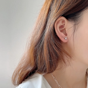925 silver cross stud earrings with sparkling cubic zirconia worn by a model