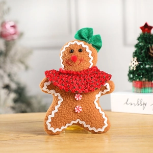 Close-up of Christmas gingerbread man plush toy with red scarf and candy button details