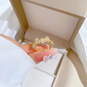Adjustable gold branch ring with white zircon stones presented in a premium gift box