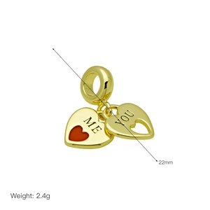 Detail of heart pendants with ME and YOU engraving, 22mm size, gold finish