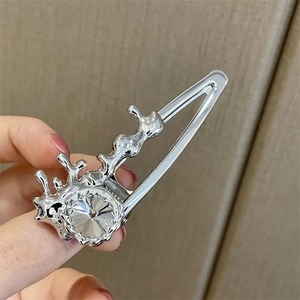 Macro di un fermaglio per capelli in metallo argentato con un grande cristallo sfaccettato