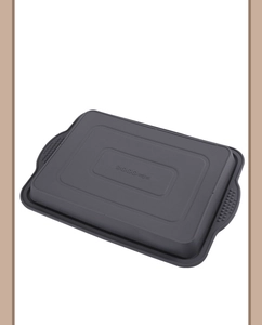 Macro detail of a gray silicone brownie baking mold with side handles on white backdrop