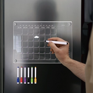 Magnetic acrylic weekly calendar board with 6 markers on a stainless steel fridge
