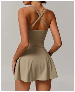 Detail view of khaki tennis dress with cross-back straps and hollow out back design