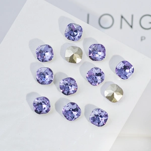 Macro shot of light purple K9 crystal rhinestones with faceted square cut and metallic backings