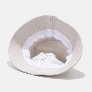 Inside view of beige cotton bucket hat showing stitching detail and white sweatband