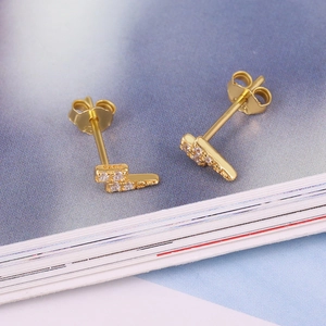 Macro shot of S925 sterling silver gold-plated lightning earrings with pavé zircon