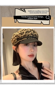 Detail view of the Y2K leopard print beret with black brim and gold button accent