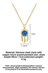 Detailed view of gold dreamcatcher pendant with blue gems and cubic zirconia feathers