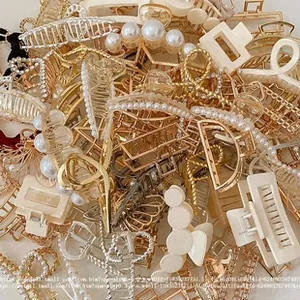 Variety of kids' gold and pearl hair clips with geometric designs in a bulk assortment