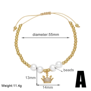 Detail view of gold beaded bracelet with pearls and crown pendant including dimensions