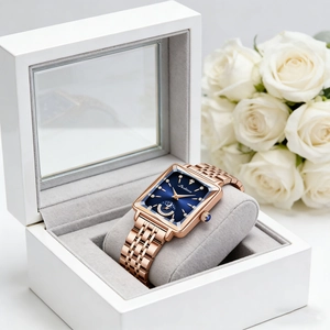 Detail of rose gold square watch with blue dial and diamond moon phase in gift box