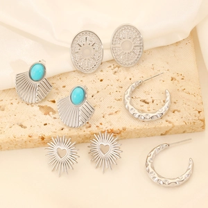 Set of four silver vintage earrings with turquoise stones and textured metal designs