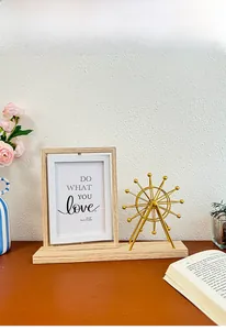 Rotating 4x6 photo frame with golden ferris wheel sculpture on wooden desktop stand