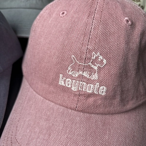 Pink washed canvas baseball cap featuring white Scottish Terrier dog embroidery