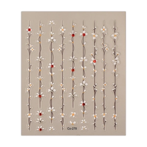 Minimalist bellflower nail stickers with floral vines and red rhinestones on grey backdrop