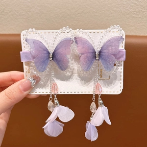 Detail of purple butterfly hair clips with long tassels and sparkling rhinestone accents