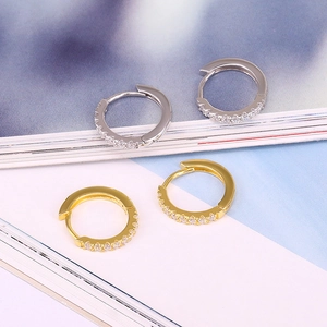Detailed view of silver and gold square hoop earrings with small cubic zirconia stones