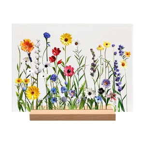 Detail of vibrant floral acrylic plaque with minimalist wooden stand for desktop decoration