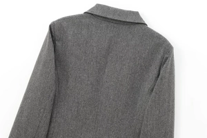 Detail of the grey herringbone fabric texture on back of double-breasted cropped blazer