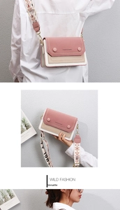 Detail view of pink and beige patchwork crossbody bag with ethnic patterned wide strap
