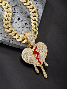 Detailed shot of iced-out gold Cuban link necklace with bleeding heart and lightning pendant