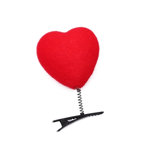 Red plush heart hair clip with spring attachment on a black duckbill clip base