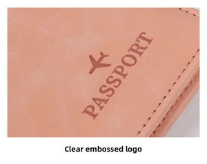 Close-up of pink leather passport cover showing embossed airplane icon and fine stitching