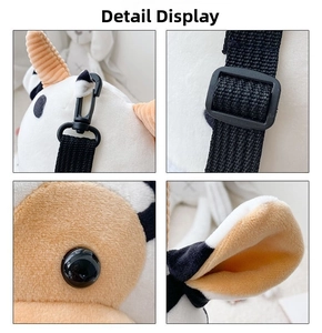 Detail view of cow plush bag showing the adjustable strap buckle and soft ear texture
