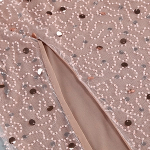 Detailed close-up of intricate hand-beaded embroidery and sequins on mesh evening gown fabric