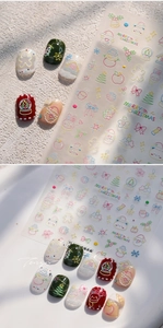 Detailed view of 3D embossed Christmas nail art stickers featuring Santa and reindeer icons
