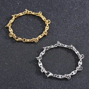 Gold and silver titanium steel pig nose link chain bracelets on black background