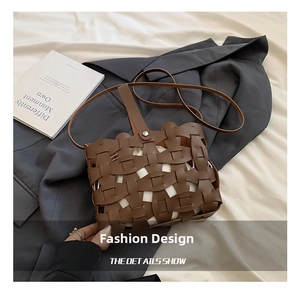 Detailed close-up of brown hollow woven crossbody bag with metallic button closure