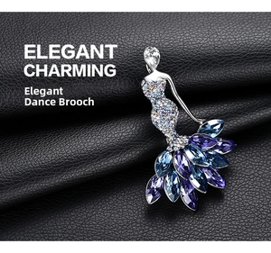 Macro shot of elegant dancer brooch with blue and purple crystals on black leather