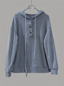 Detail of blue ribbed knit hoodie showing wooden buttons and textured drawstring hood