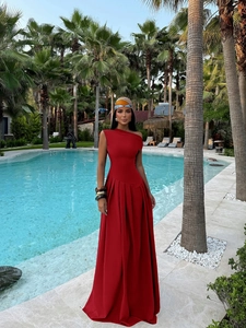 Detailed view of elegant red one-shoulder evening dress with pleated maxi skirt for formal gala