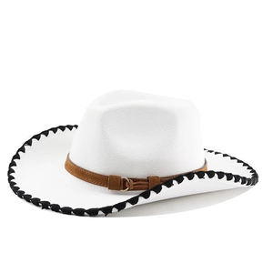 Detailed view of white cowboy hat with black woven edge and brown leather strap buckle