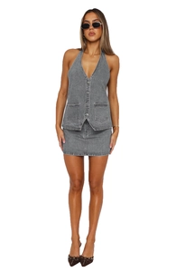 Close-up of grey washed denim vest set with deep V-neck design and raw-cut hem details