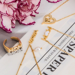 Detailed shot of golden MOM jewelry set with pearls and rhinestones on carnations