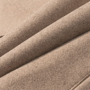 Macro detail of high-quality camel wool fabric showing soft texture and thick fiber weave