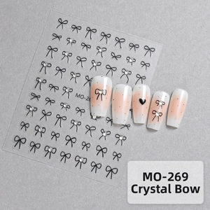 Detailed view of MO-269 5D bow nail decals with crystals on pink gradient nails