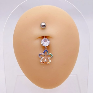 Detailed macro view of silver flower navel ring with colorful zircons on silicone model