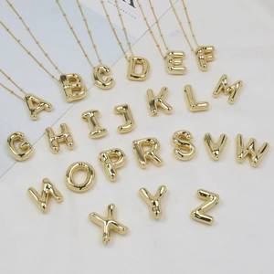 3D chunky gold initial necklaces A-Z alphabet bubble pendants on white background