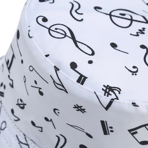 White double-sided bucket hat featuring black musical note prints and premium stitching